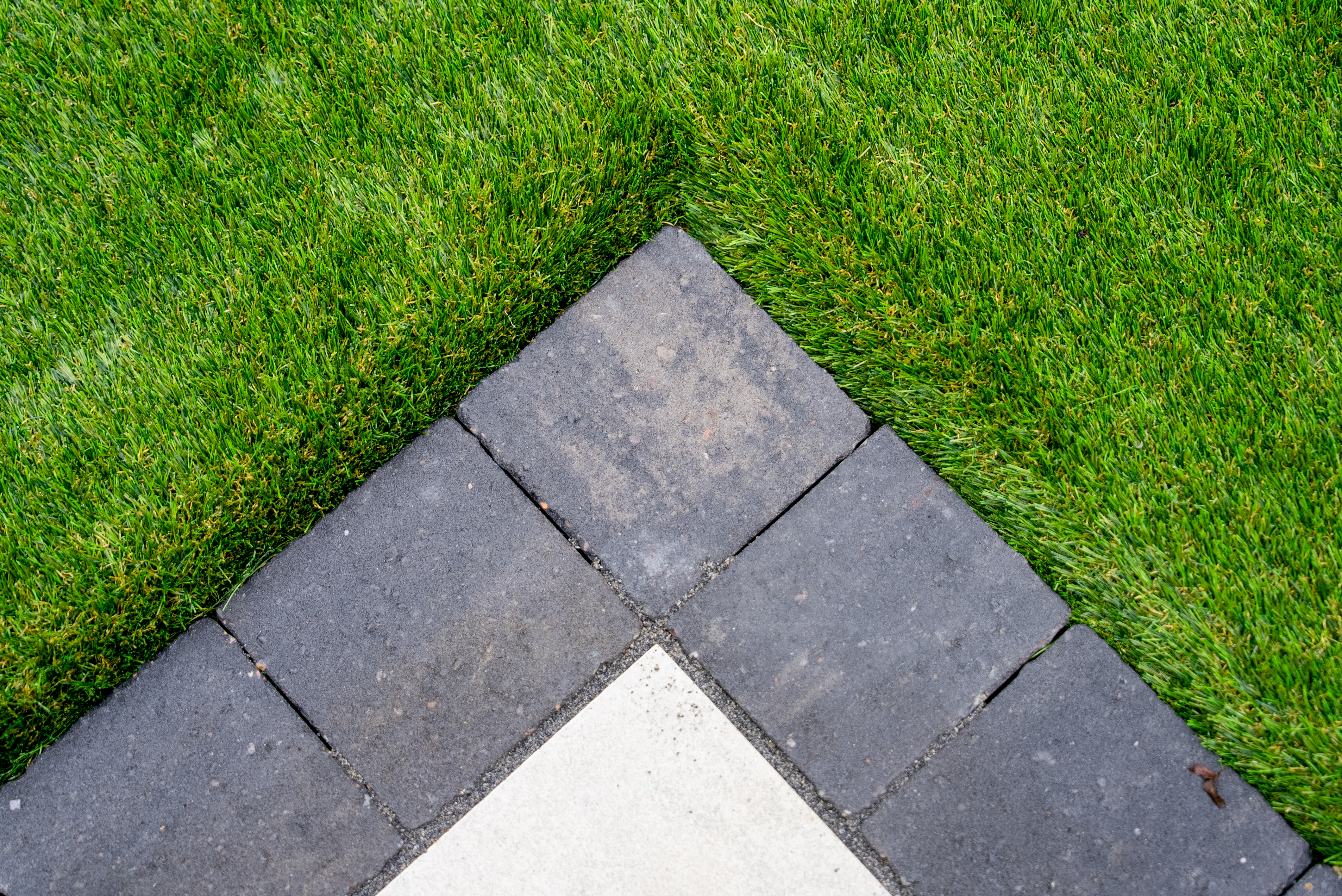 Artificial grass and porcelain paving edge detail Norwich